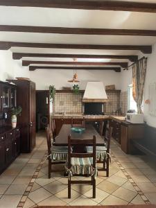 a kitchen with a table and chairs in it at Villa Castello Andria in Castel del Monte