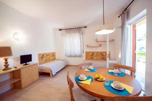 a living room with a wooden table and a dining room at Residence Capobianco in Portoferraio