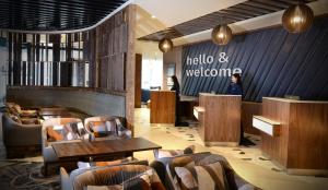 a lobby of a restaurant with tables and chairs at Travelodge PLUS Dublin City Centre in Dublin