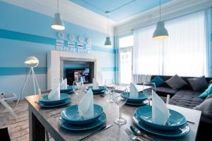 a living room with a table with plates and wine glasses at Ferienwohnung bis 8 Personen in Berlin