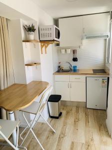 a small kitchen with a wooden table and a wooden floor at Apartamento Playa de Mendez in Alcalá