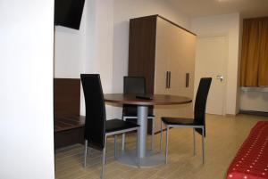a dining room with a table and black chairs at Piazza Dante in Taranto