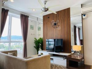 a living room with a couch and a television at Hejmo Suites in George Town