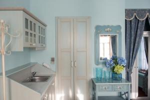 a kitchen with a sink and a mirror at Dandy Villas Nymfaio - Snow Fairy - Sauna in Nymfaio