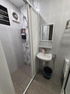 a small bathroom with a sink and a shower at Voon 2 bedroom homestay in Mersing