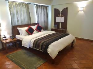 a bedroom with a large bed with pillows on it at Khwapa Chhen in Bhaktapur