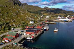 an aerial view of a harbor with boats in the water at Fish factory -The real Lofoten experience in Ballstad