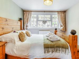 a bedroom with a large bed and a window at Elsies Cottage in Pontesbury