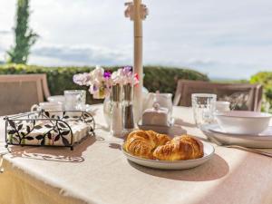 a table with a plate of croissants on it at Elsies Cottage in Pontesbury