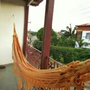 a hammock on the porch of a house at Hostel Lumiar da Serra in Tiradentes