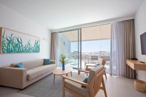 a living room with a couch and a table at Apartaments Posidonia in Colònia de Sant Jordi