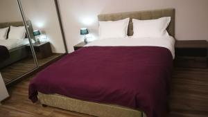 Ένα ή περισσότερα κρεβάτια σε δωμάτιο στο BEST APARTHOTEL EVER! next to Airport Otopeni