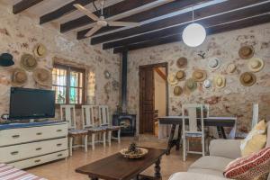 a living room with a tv and a couch and a table at Finca Son Matginet 18 in Sineu