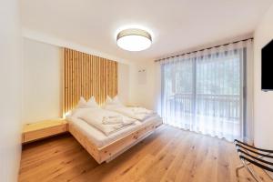 a bedroom with a bed and a large window at Apartment Ub31 One in Eggen