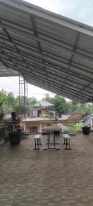 a pavilion with a table and benches in a patio at kopi ABG in Lawang