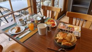 a table with a tray of breakfast food on it at Hotel Beau-Séjour in Leukerbad