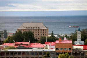 a large building with a clock tower on top of it at Hotel Cabo De Hornos in Punta Arenas