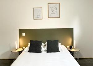 a bedroom with a large white bed with two tables at LE TROPICAL - Terrasse & Parking in Mont-de-Marsan