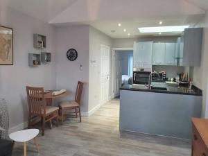 a kitchen with a counter and a table and chairs at Priory Annex Guest Accommodation Lincoln in Lincolnshire