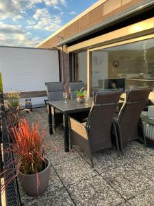 a patio with a table and chairs and plants at Penthouse ,,Kleine Auszeit" in Bad Harzburg