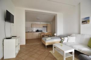 a living room with a white couch and a table at Workers Apartment Troisdorf Spich in Spich