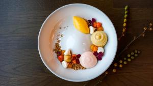 a white bowl filled with food on a table at Sorrisniva Arctic Wilderness Lodge in Alta