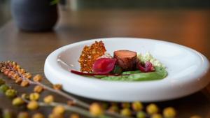 a white plate of food on a table at Sorrisniva Arctic Wilderness Lodge in Alta +37 photos