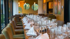a long table in a restaurant filled with wine glasses at Sorrisniva Arctic Wilderness Lodge in Alta