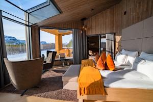 a bedroom with a bed and a large window at Sorrisniva Arctic Wilderness Lodge in Alta