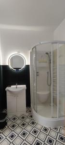 a bathroom with a shower and a toilet and a sink at Guest Home location in Néris-les-Bains
