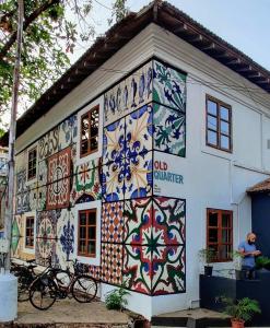 a building covered in colorful tiles on the side of it at The Old Quarter Hostel in Panaji