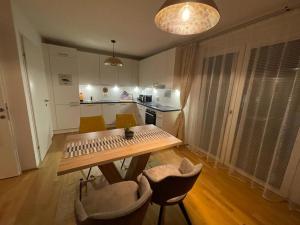 a kitchen with a table and chairs in a room at Lovely 3 rooms apartment viena in Vienna