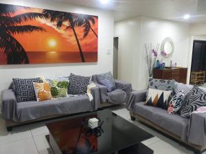 a living room with two couches and a coffee table at Bamboo Villa in Port Vila