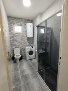 a bathroom with a shower and a toilet and a sink at Katerina's Apartment in Bitola