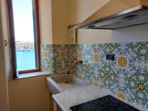 a bathroom with a sink and a window at Casa Calata in Portoferraio +11 photos