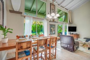 a dining room with a wooden table and chairs at Puamana 9B in Princeville