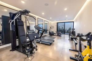 a gym with treadmills and ellipticals in a building at Endless Summer - 2Bed 2Bath Condo - Seasonly Heated Pool with Ocean Views - 5min walk to Beach - Fibre Internet - Sleeps 6 in Cabo San Lucas