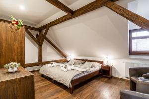 a bedroom with a bed and a couch at Apartmány in Veritas in Mikulov