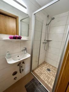 a bathroom with a shower and a sink at Ferienhaus Wiesenlandl in Bischofswiesen