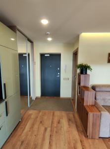 an office with a hallway with wooden floors and a door at Apartments Franny's Bees in Vilnius