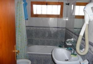 a bathroom with a tub and a sink and a shower at Las Americas beach apartment in Playa de las Americas