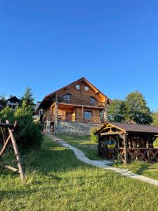 a large wooden house with a pathway in front of it at Villas by Vysche Neba in Palyanytsya