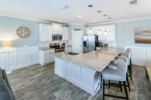 a kitchen with white cabinets and a large island at Near The Mayo Clinic 2 Blocks From Ocean 4 Bedroom Pet Friendly Home in Jacksonville Beach
