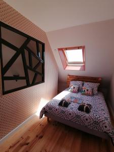 una camera da letto con un letto con due cani sopra di Le biez de la Fresnais a La Fresnais