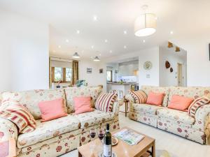 a living room with two couches and a table at The Ark Barn in Chillenden