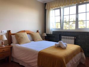 a bedroom with a bed with two white towels on it at Apartamentos Montemar in Navia