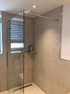 a shower with a glass door in a bathroom at Beautiful Apartment with a huge private terrace 
