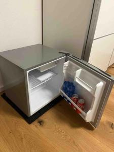 an empty refrigerator with its door open in a kitchen at Beautiful Apartment with a huge private terrace in Speinshart