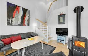 a living room with a couch and a wood stove at Stunning Apartment In Ringkbing With 2 Bedrooms, Sauna And Wifi in Søndervig