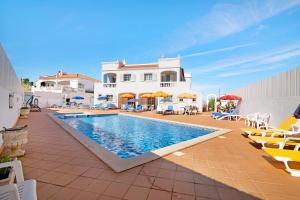 a villa with a swimming pool in front of a house at Apartamentos Arcadia - Ana in Guia